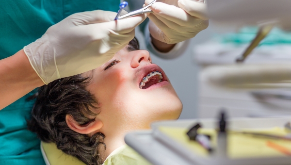 Dentist treating orthodontic patient that found them after dental marketing campaign