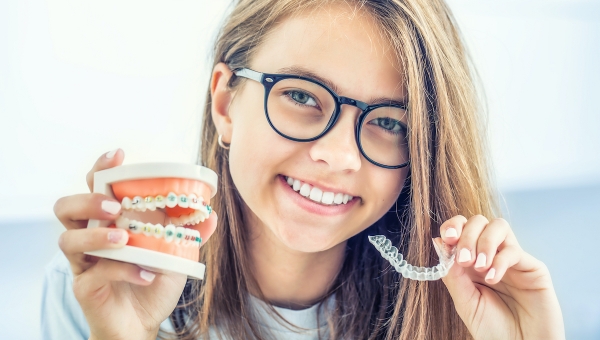 Dental braces patient comparing metal braces with Invisalign