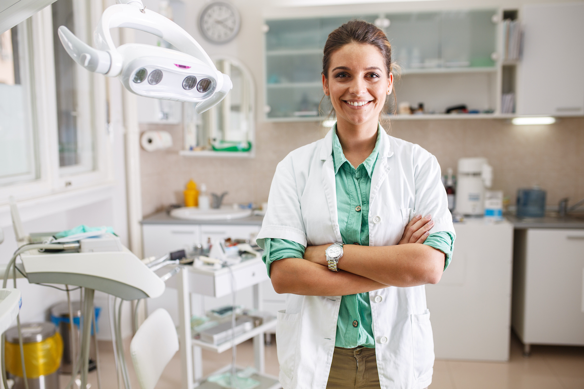 Dentist standing in her office