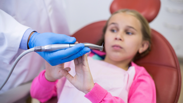 Young girl feeling anxious about her dental check-up