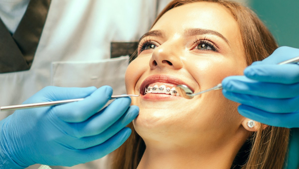 orthodontist conducting an exam on a new patient