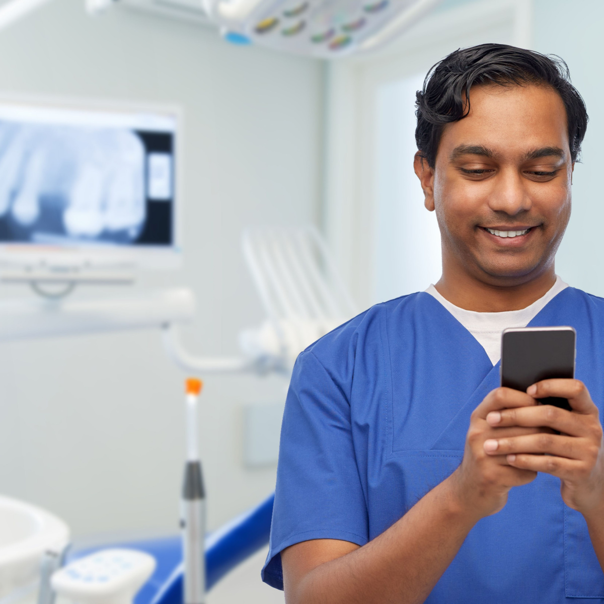 A dentist using the OrthoPhoto app on his phone