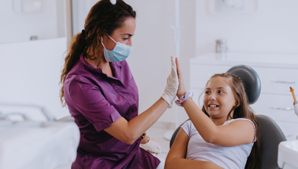 A happy dentist and her patient