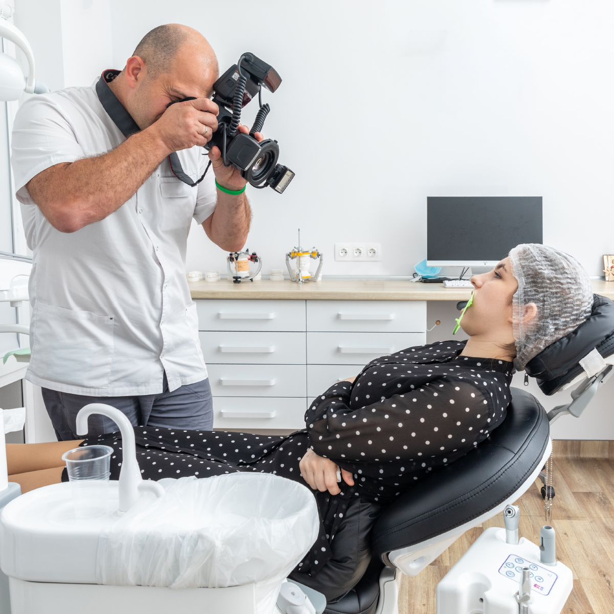 Dentist photographing a patient's teeth for a medical record